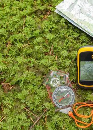 A GPS, a compass and a map on the ground