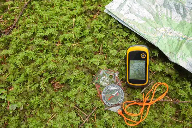 A GPS, a compass and a map on the ground