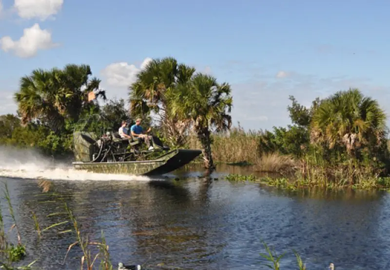 Duck hunters on an airboat on a river in Florida