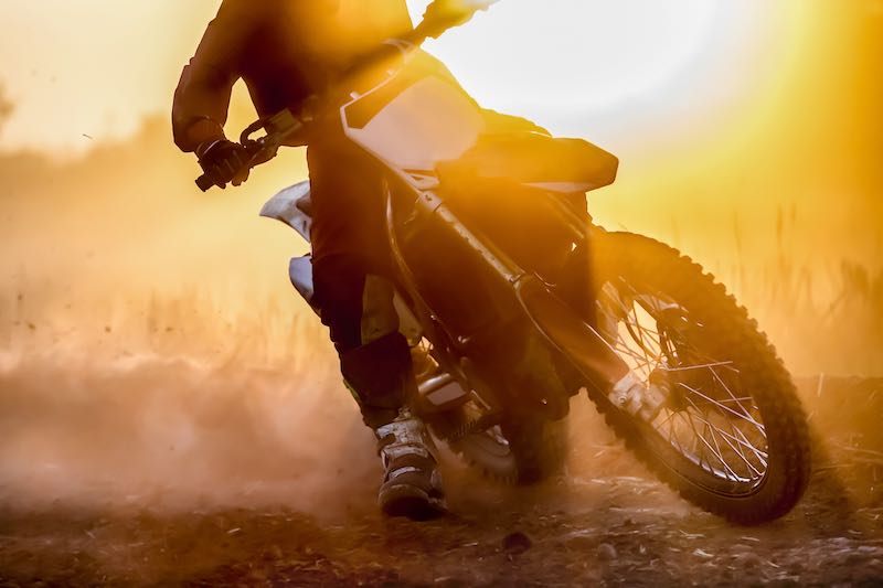 Man riding a dirt bike at sunset