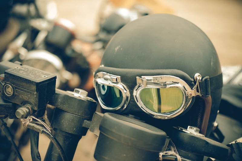 Dark green retro helmet on display in motorcycle exhibition