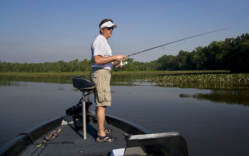 Man fishing for bass on a boat in Central Florida