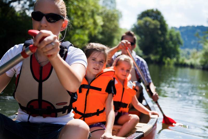 Family canoeing on a river in Central Florida. Canoe Rental in Central Florida