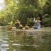 Family Of Four Canoing On A River in Central Florida