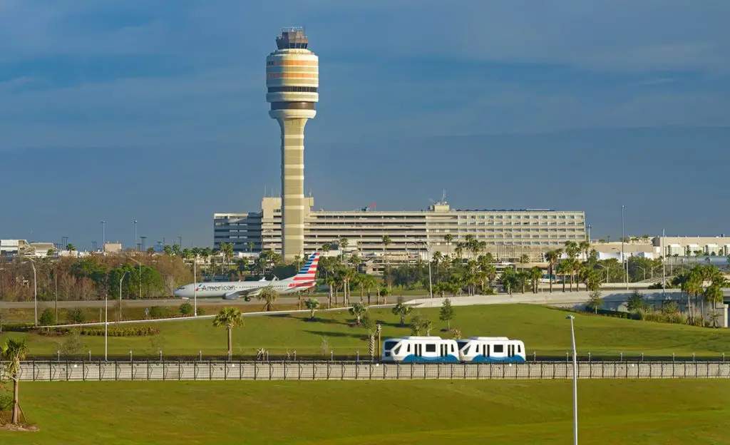 Orlando International Airport North terminal with airplane and people mover in the foreground