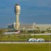 Orlando International Airport North terminal with airplane and people mover in the foreground